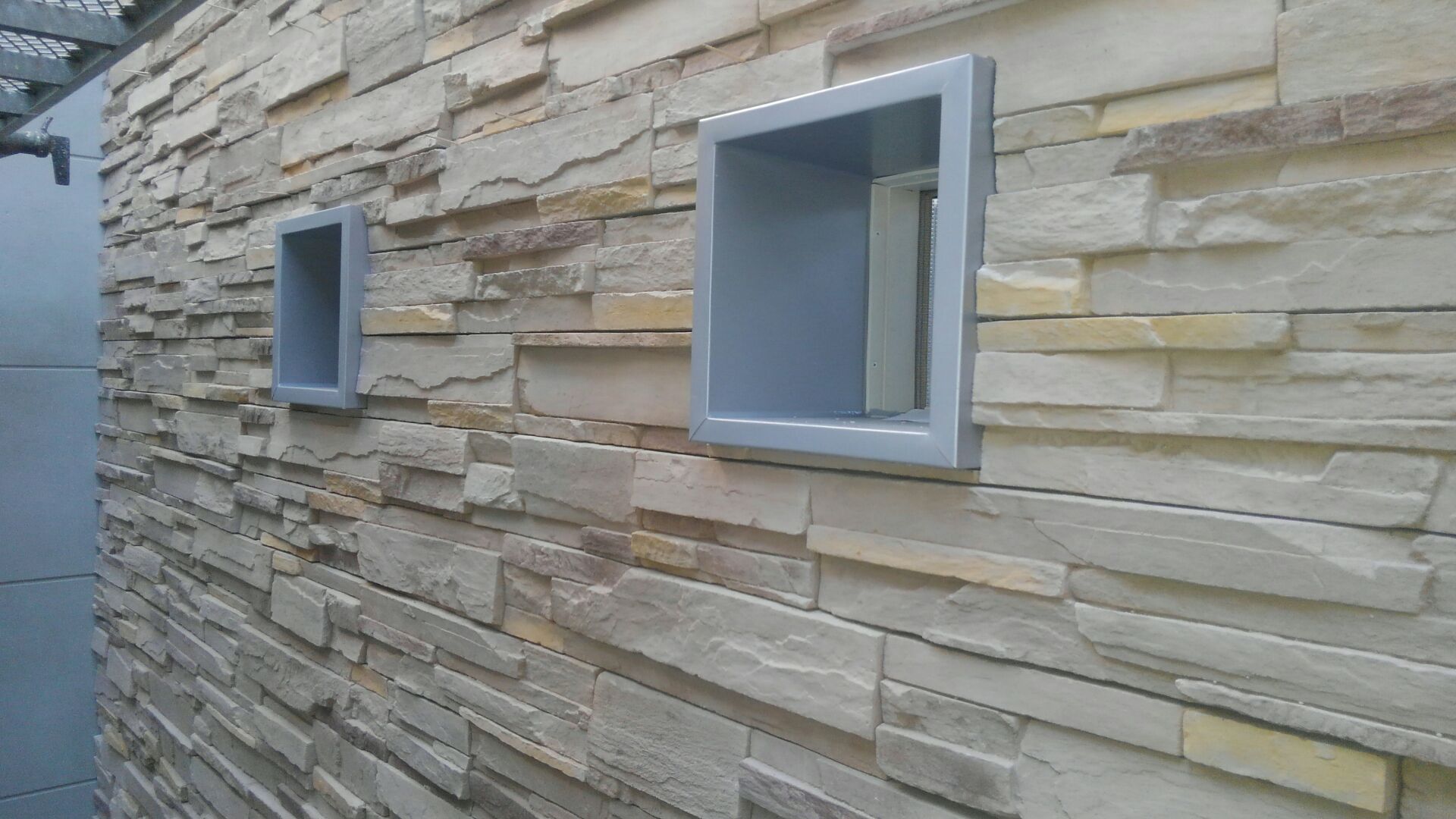 中庭の壁一面だけ石材っぽく見えるサイディングを貼りました。少しお高めですがヤッパリいいものはイイですね！